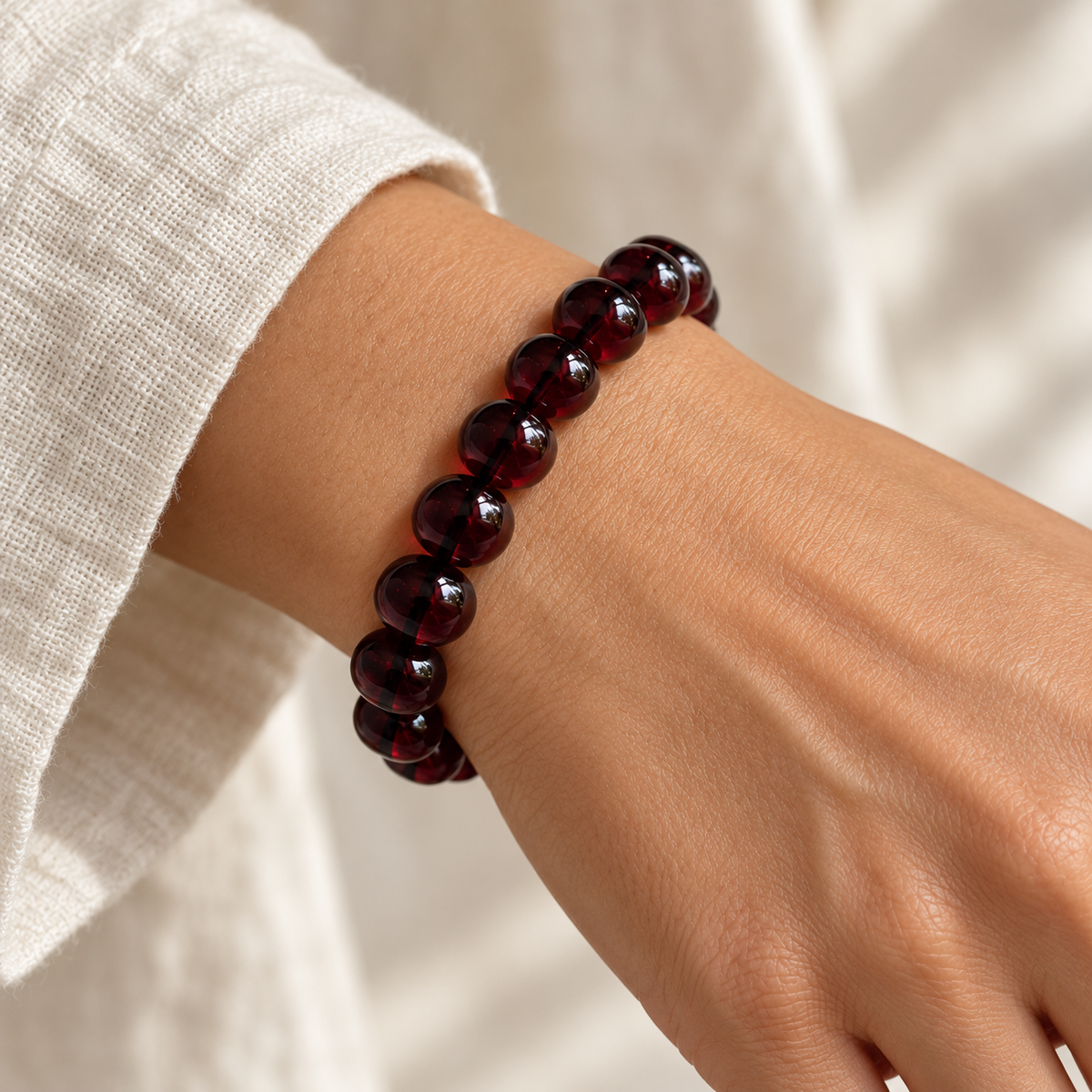 Deep cherry red bracelet with polished 10 mm round beads, shown with a 25 cm circumference and bead measurements.